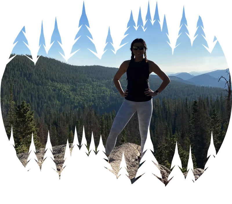 A Tree Peace founder standing above a forested valley, framed by tree silhouettes
